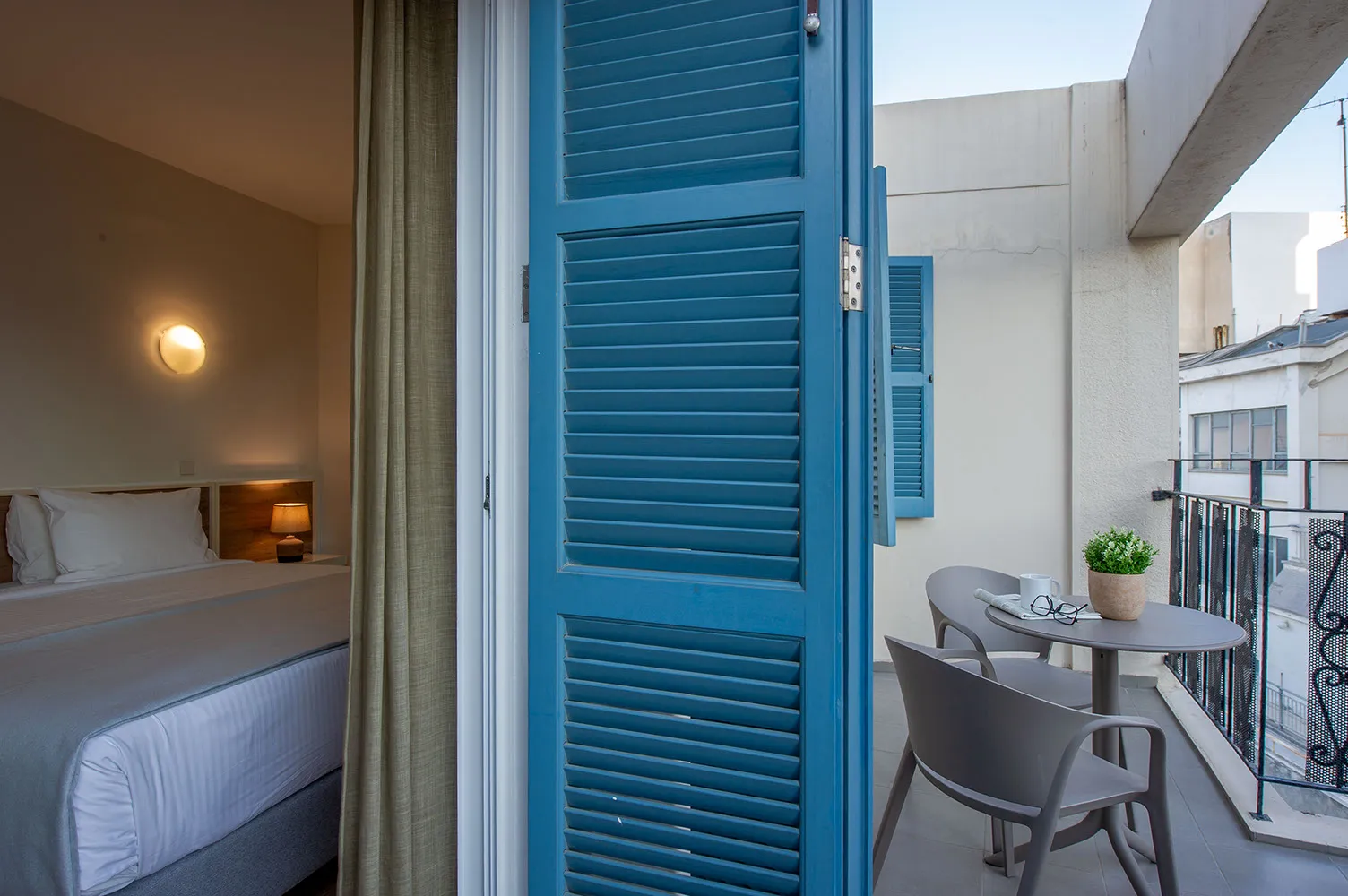 Balcony with blue shutters and seating